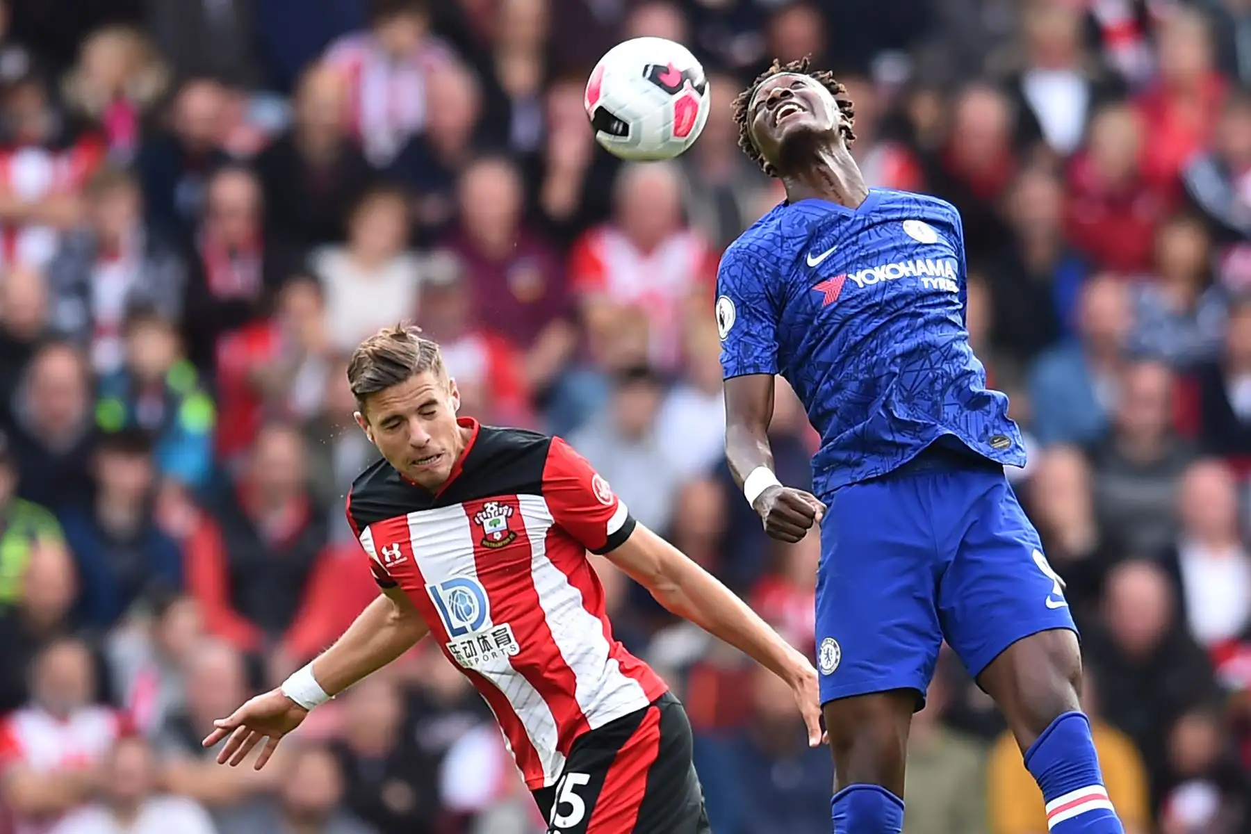 El defensor polaco de Southampton Jan Bednarek disputa el balón contra el delantero inglés del Chelsea Tammy Abraham. Foto: AFP