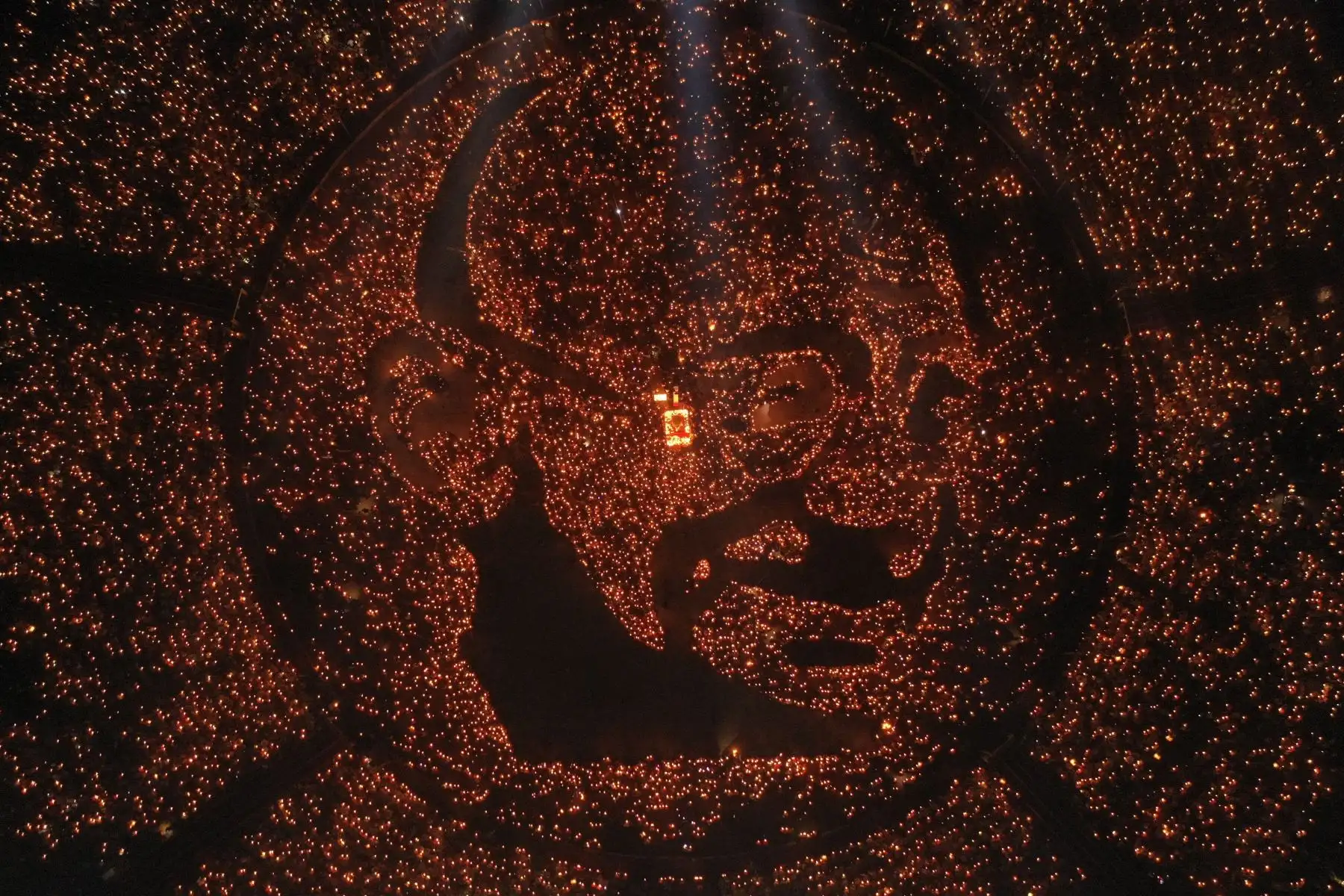 Retrato del ícono de la independencia india Mahatma Gandhi iluminado por 30,000 miles de devotos hindúes sosteniendo lámparas de aceite encendidas para conmemorar su 150 aniversario de nacimiento mientras participan en un Maha Aarti (un ritual hindú), en la India occidental.