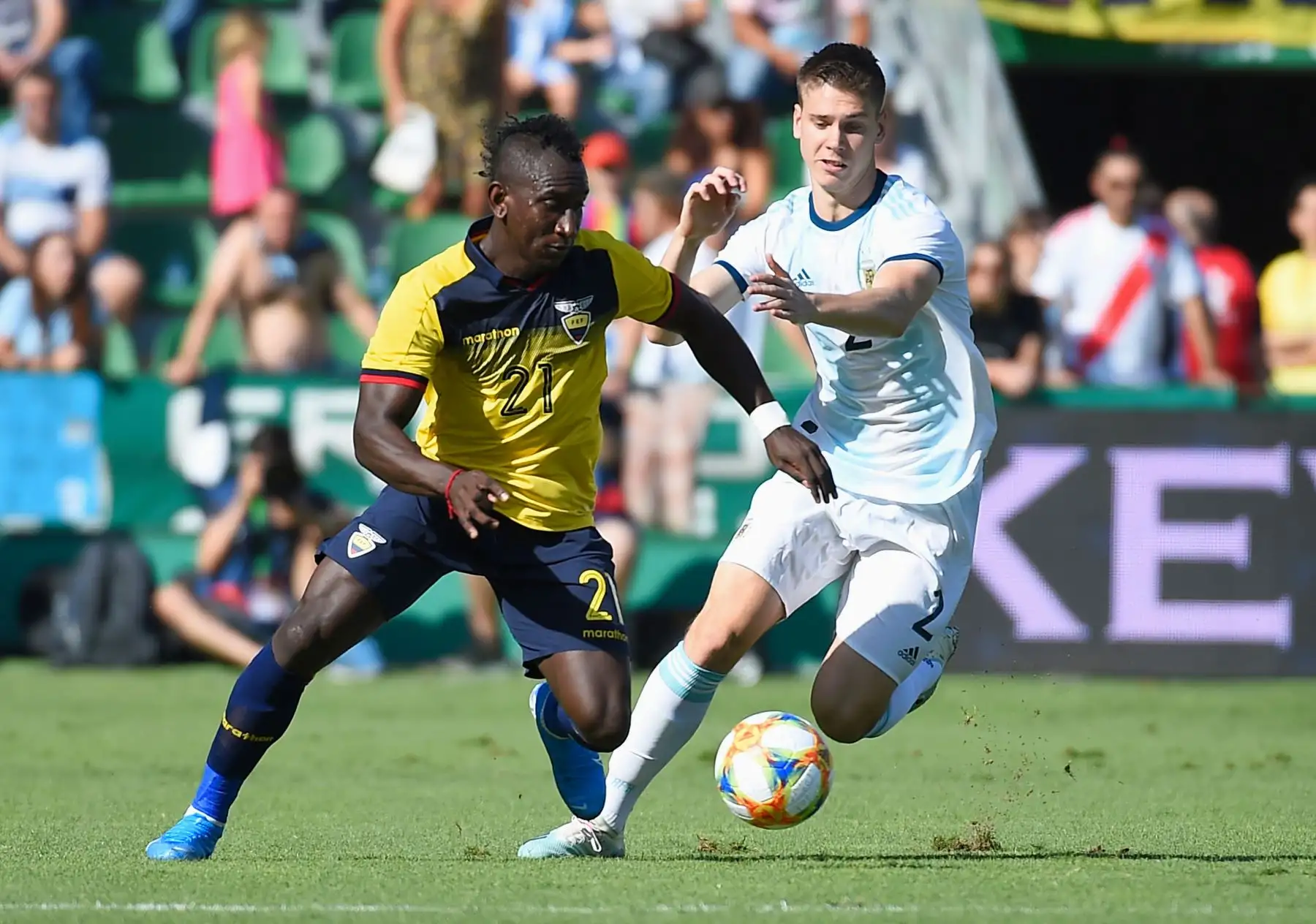 El mediocampista ecuatoriano Erick Castillo compite contra el defensor argentino Juan Foyth en partido amistoso disputado en estadio Martínez Valero, en España. Foto: AFP