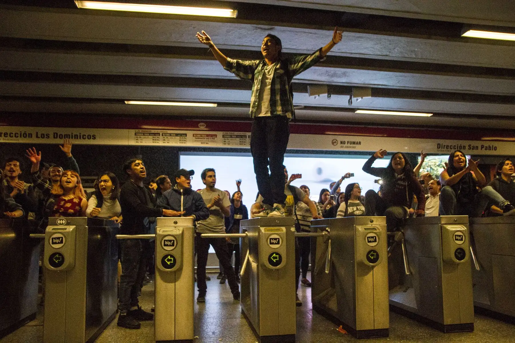En esta foto publicada por Aton Chile, los estudiantes se manifiestan en la estación de metro Los Heroes durante una protesta masiva de evasión de tarifas en Santiago, Chile. AFP