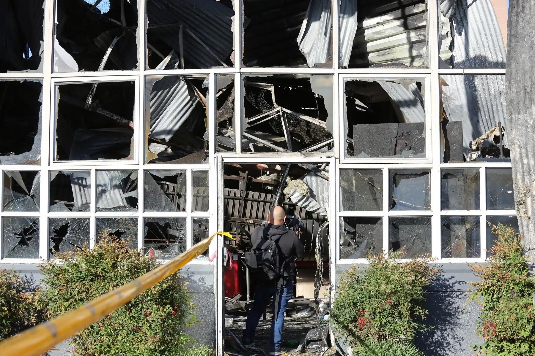 Personal policial y bomberos inspeccionan un supermercado después de ser saqueado e incendiado por manifestantes, en medio de la coyuntura de protestas en Santiago. Foto: EFE