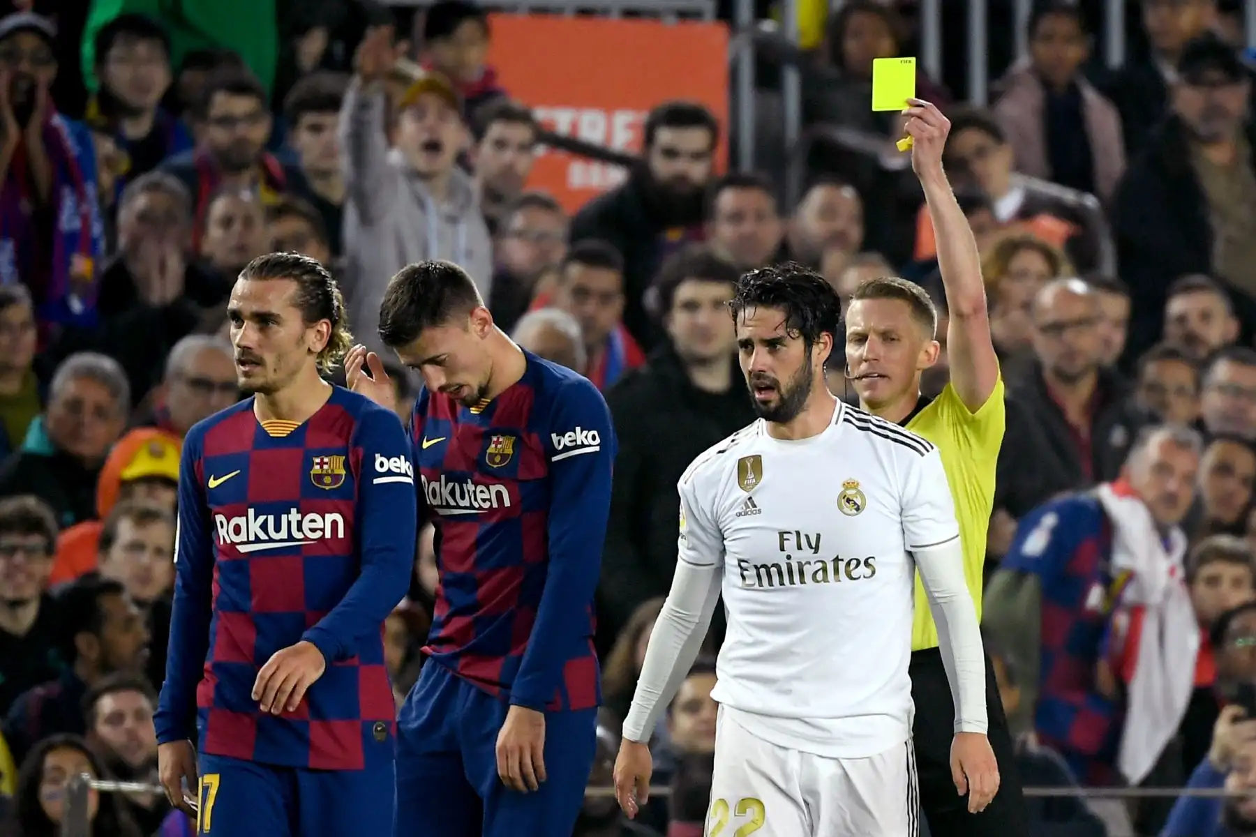 El árbitro español Alejandro Hernández muestra una tarjeta amarilla al defensa francés de Barcelona Clement Lenglet  durante el partido de fútbol de la Liga española "El Clásico" entre el FC Barcelona y el Real Madrid CF.
Foto: AFP