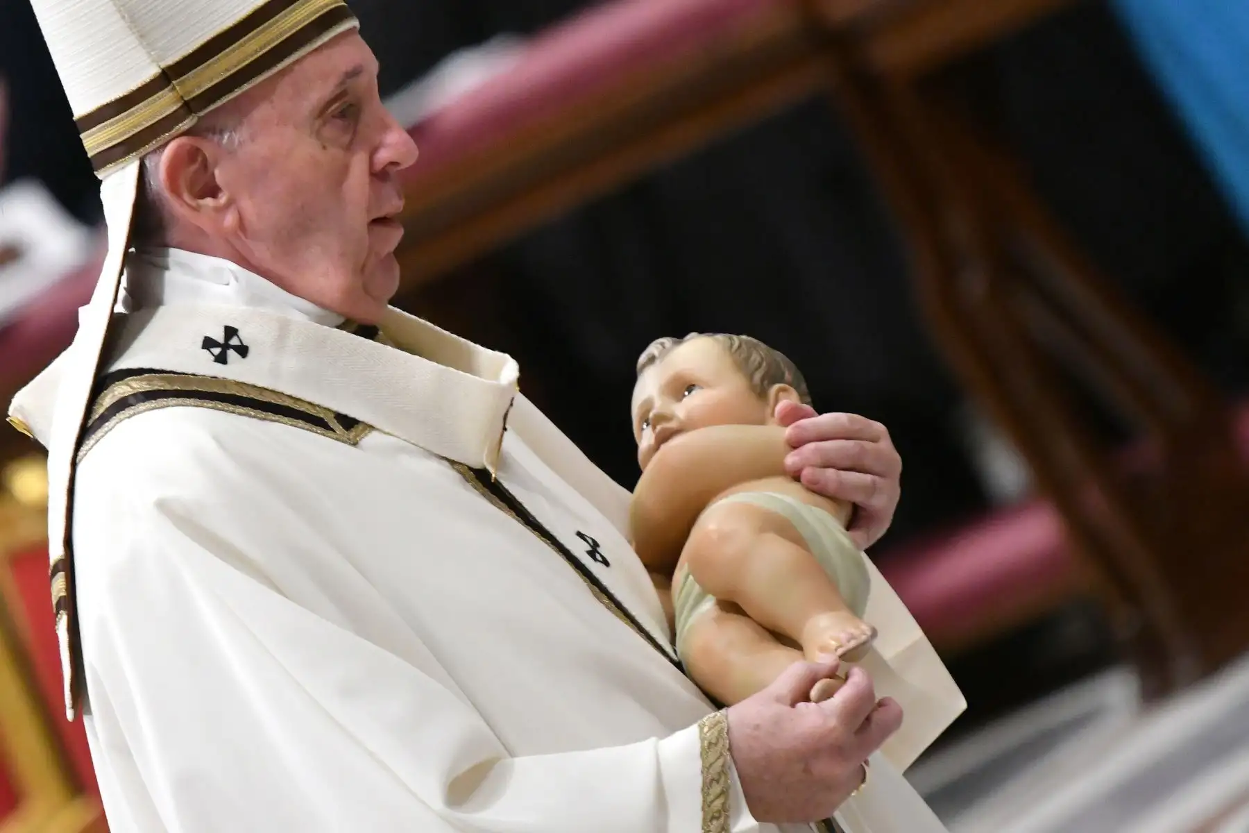 El Papa Francisco lleva una estatua del niño Jesús durante una misa en la víspera de Navidad que marca el nacimiento de Jesucristo  en la basílica de San Pedro en el Vaticano.
Foto: AFP