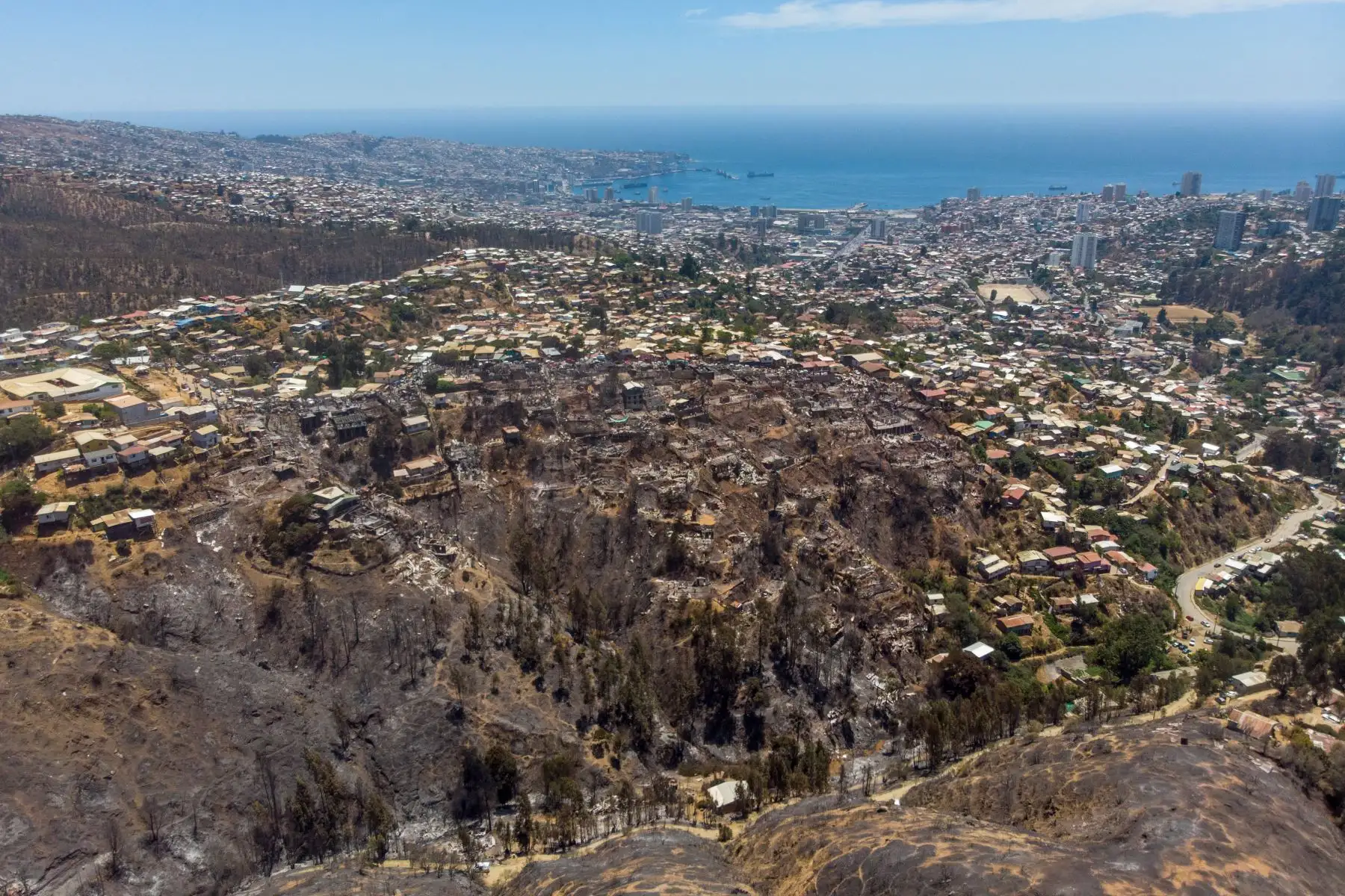 Vista aérea de casas quemadas después de un incendio forestal en el cerro Rocuant en Valparaíso, Chile.
Foto: AFP