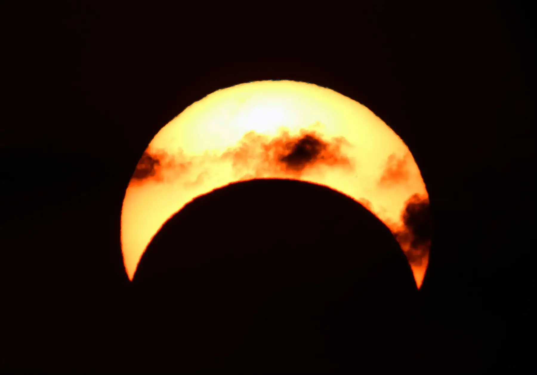 Vista del sol en la ciudad de Kuwait durante el eclipse parcial de sol. Foto: AFP