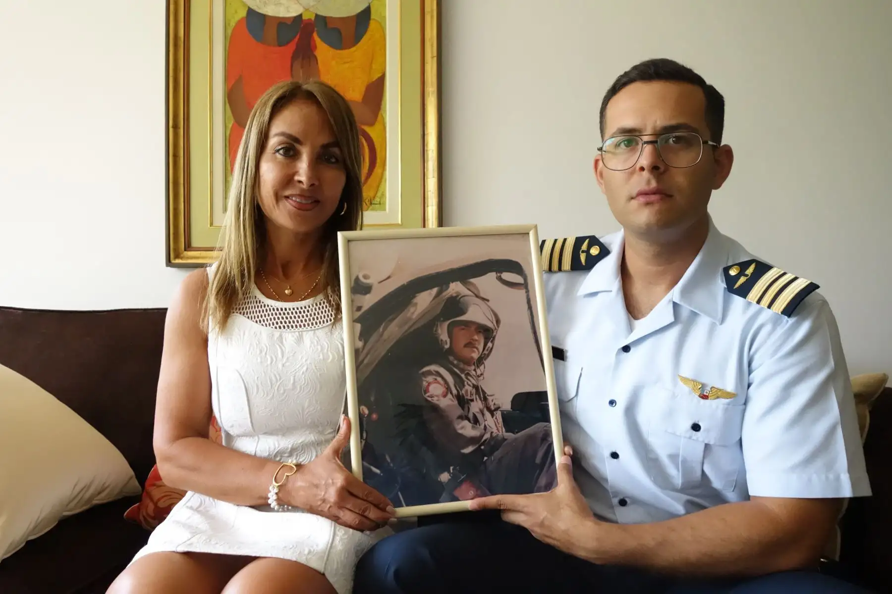 Madre e hijo del coronel Marco Schenone muestran un cuadro con su imágen, objetos personales del héroe limeño se resguardan en el palacio Rospigliosi, de la Fuerza Aérea del Perú (FAP), en el Cercado de Lima.
Foto: ANDINA/Difusión José Vadillo