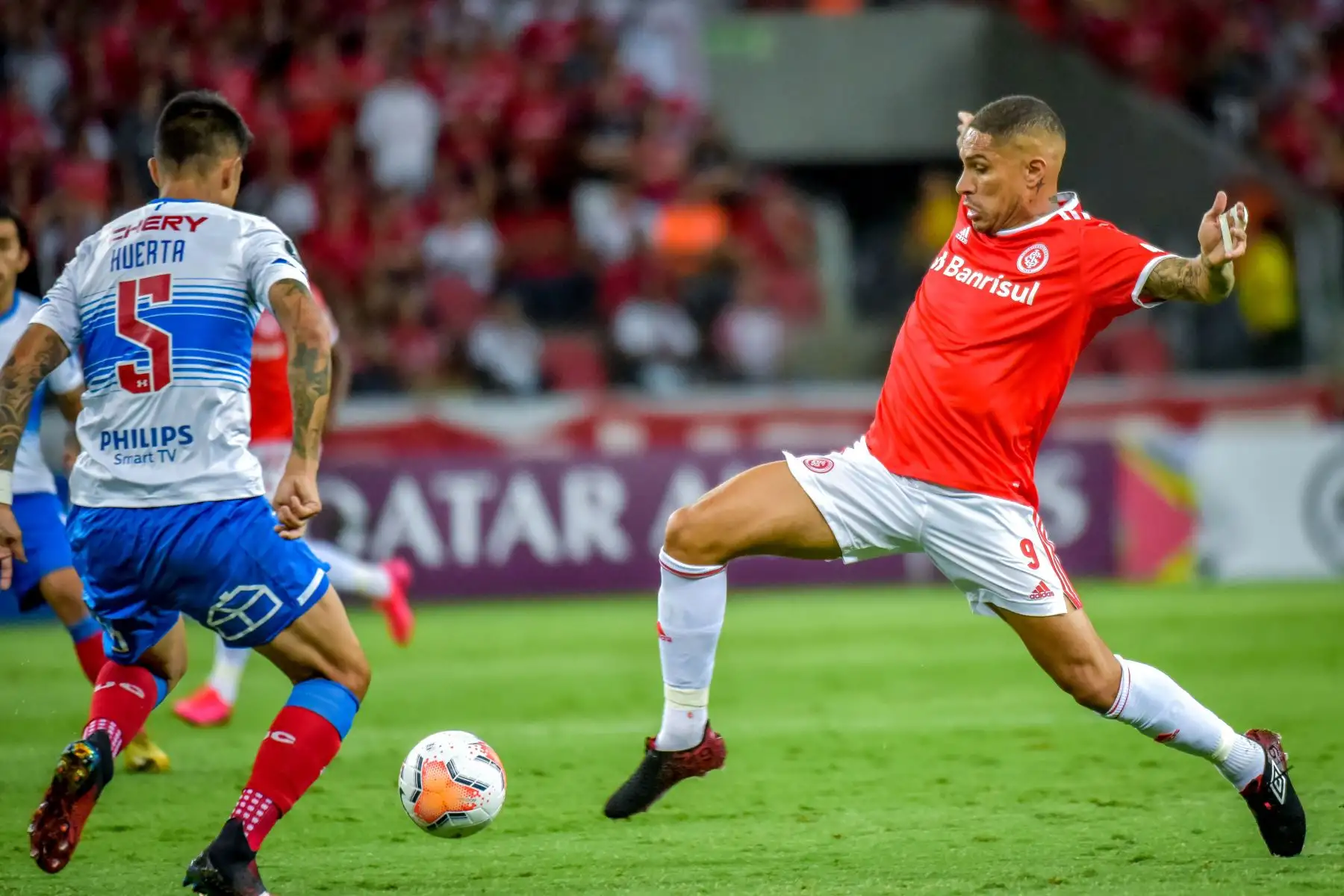 El internacional brasileño Paolo Guerrero  compite por el balón con la Universidad Católica de Chile Valber Huerta durante su partido de la Copa Libertadores 2020 en el estadio Beira-Rio, en Porto Alegre, Brasil, el 3 de marzo de 2020