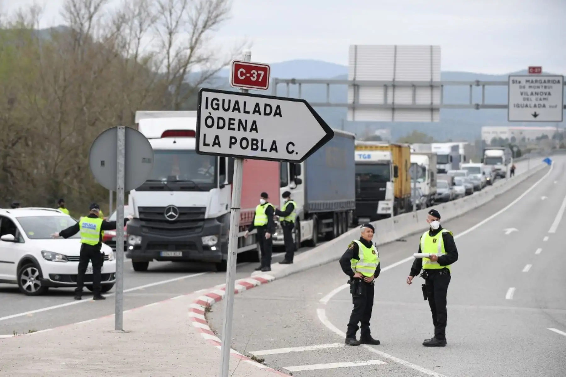 Miembros de la policía regional catalana Mossos  detienen el tránsito vehicular. Foto: AFP