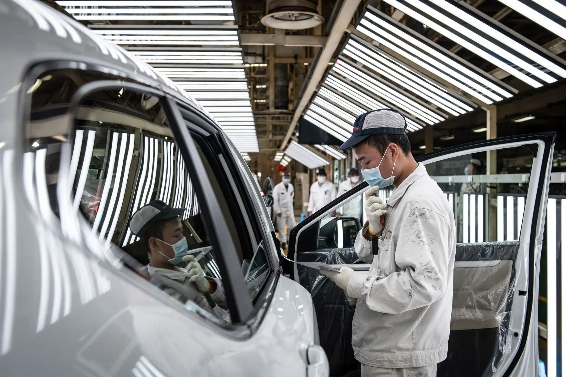 Un empleado con una máscara facial trabajando en una línea de ensamblaje en una planta de automóviles de Dongfeng Honda en Wuhan.
Foto: AFP