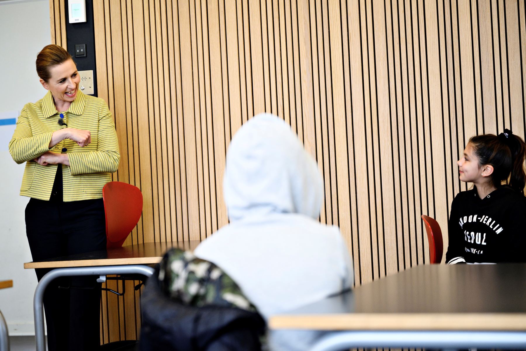 La primera ministra danesa, Mette Frederiksen (izq.), hablando con los alumnos cuando participa en la reapertura de la escuela Lykkebo en Valby en Copenhague, Dinamarca, el 15 de abril del 2020. Foto: Efe.