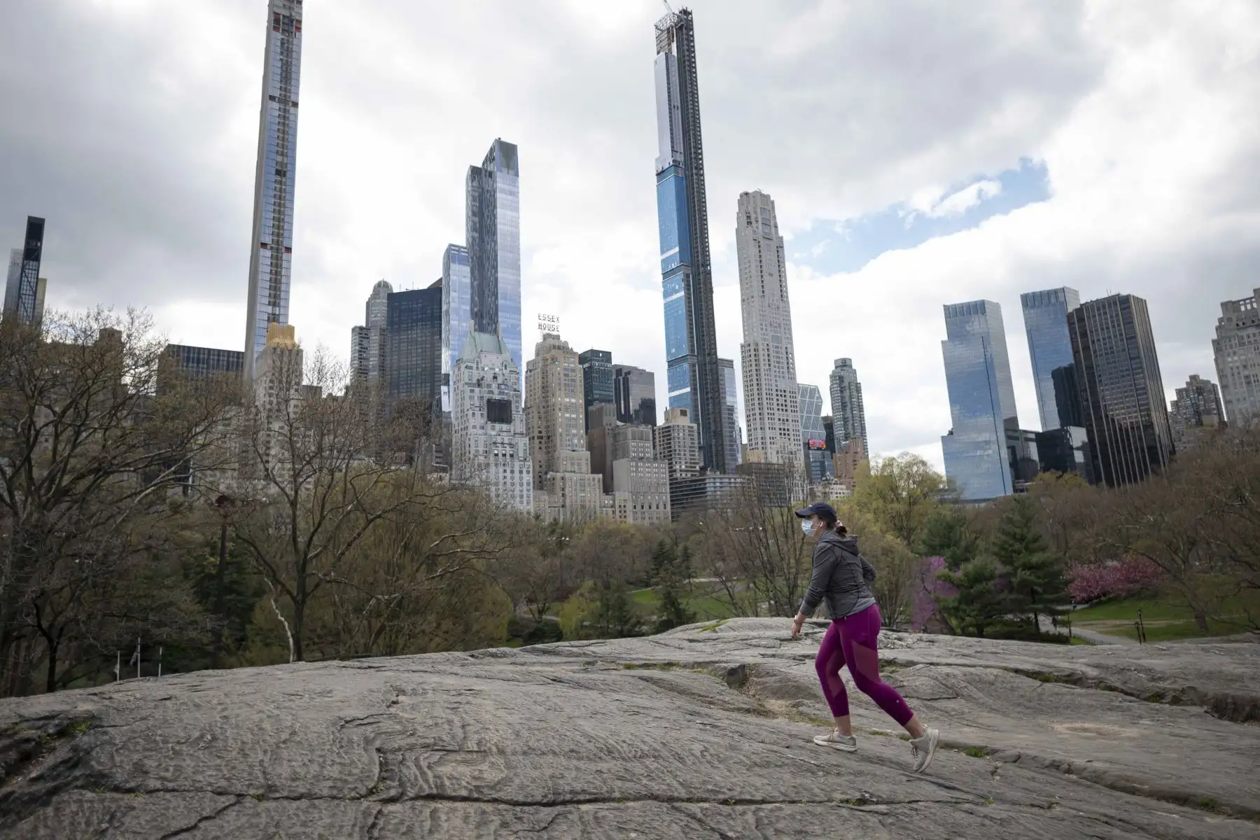 Una mujer con una máscara camina en el casi desierto Parque Central de Manhattan en la ciudad de Nueva York. Foto: AFP