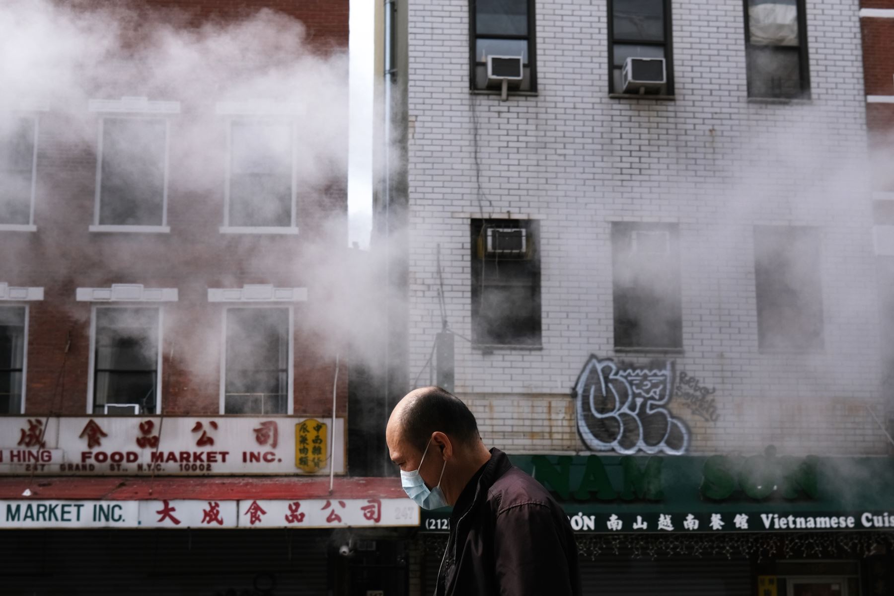 La gente camina por una calle en Chinatown mientras el coronavirus mantiene cerrados los mercados financieros y las empresas el 21 de abril de 2020 en la ciudad de Nueva York. Foto: AFP