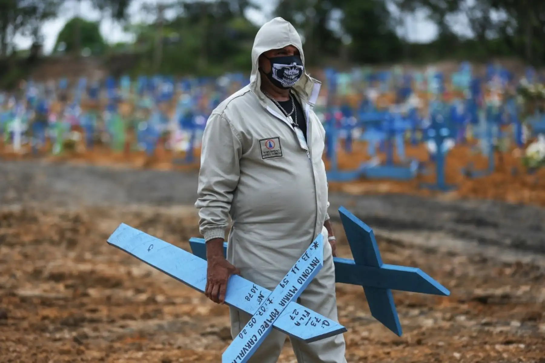 El brasileño Ulisses Xavier, de 52 años, que ha trabajado durante 16 años en el cementerio Nossa Senhora en Manaos, Brasil, se prepara para colocar cruces en las tumbas. Foto: AFP