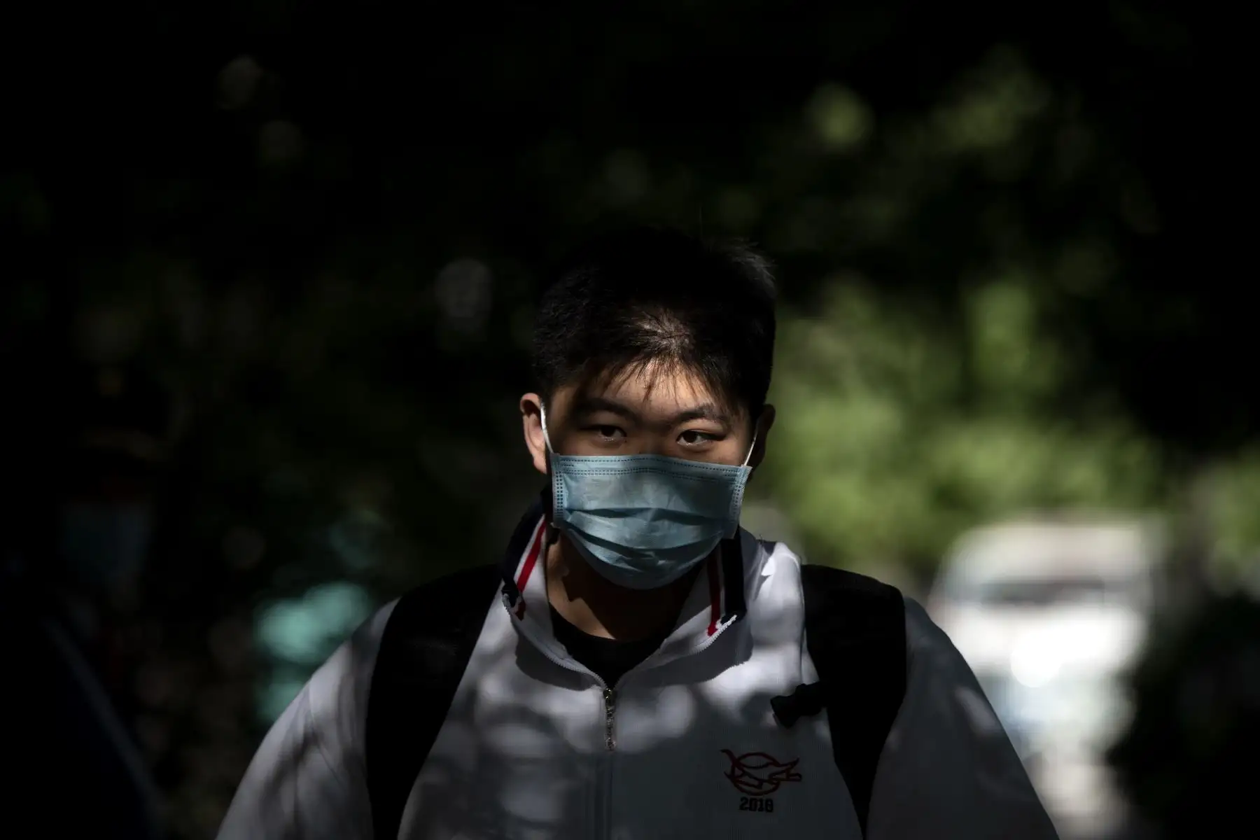 Un estudiante con una máscara facial en medio de preocupaciones por el coronavirus COVID-19 llega a una escuela secundaria en Beijing el 11 de mayo de 2020. Foto: AFP