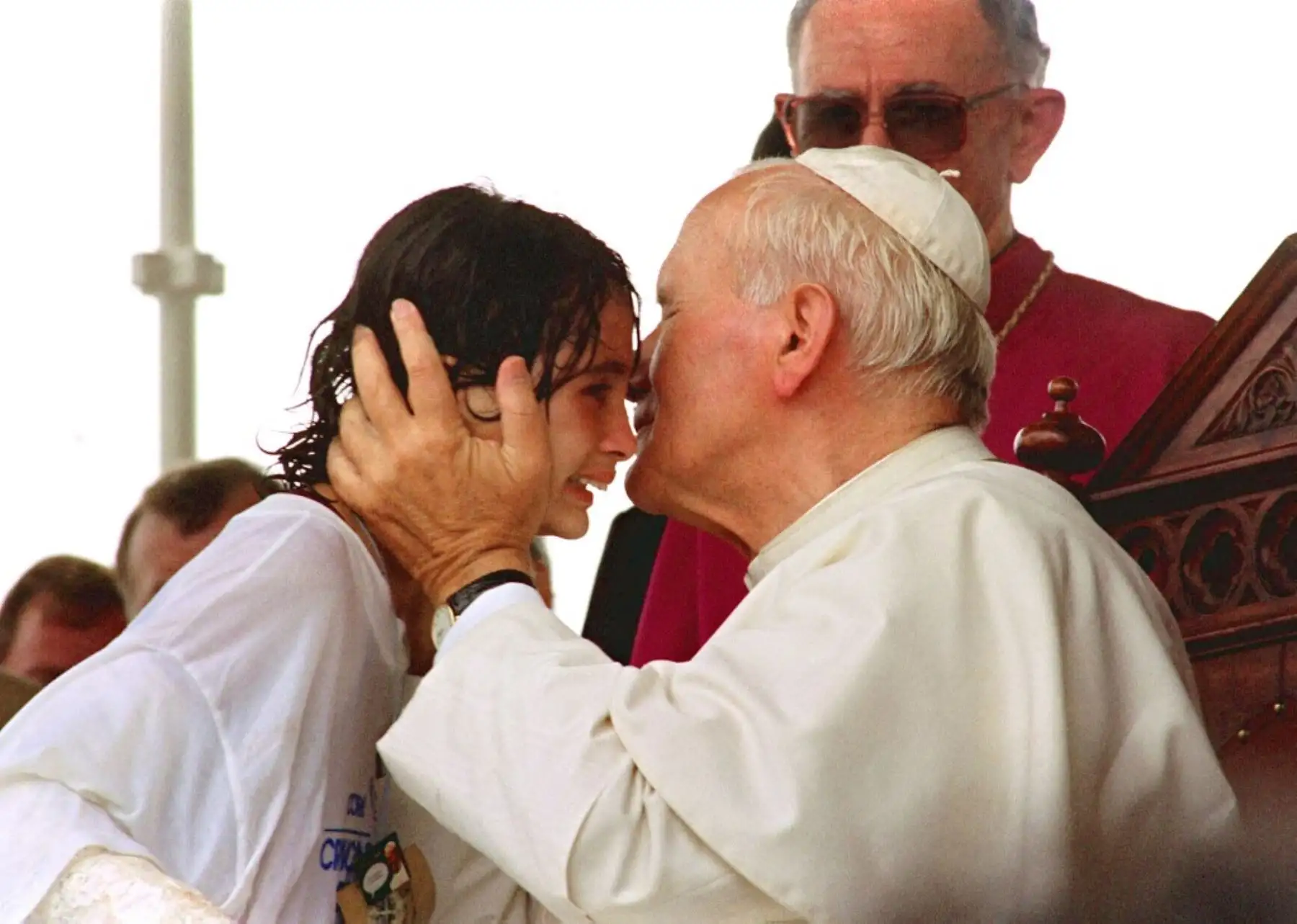El Papa Juan Pablo II besa el 19 de octubre de 1991 a Giselly Acevedo, de 10 años, quien rompió las líneas de seguridad durante la visita del pontífice de las favelas Do Lixao Sao Pedro en las afueras de la ciudad de Vitoria. El pontífice habló sobre la doctrina social de la iglesia católica durante esta etapa de su visita pastoral a Brasil del 12 al 21 de octubre de 1991 y su 53ª visita pastoral internacional. 
Foto: AFP
