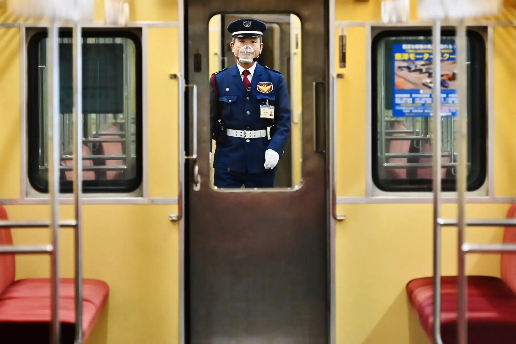 Un miembro del personal de seguridad con una máscara facial, en medio de las preocupaciones por el coronavirus covid-19, revisa los vagones del tren en la estación terminal de la Línea Asakusa en Tokio 

Foto: AFP