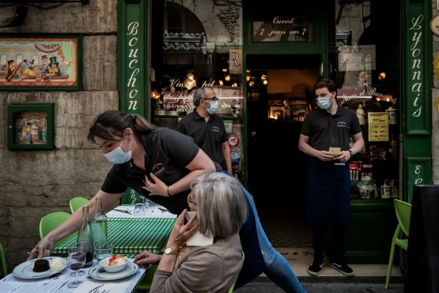 Un camarero sirve a un cliente en un restaurante local típico conocido como "Bouchon Lyonnais". Foto: AFP