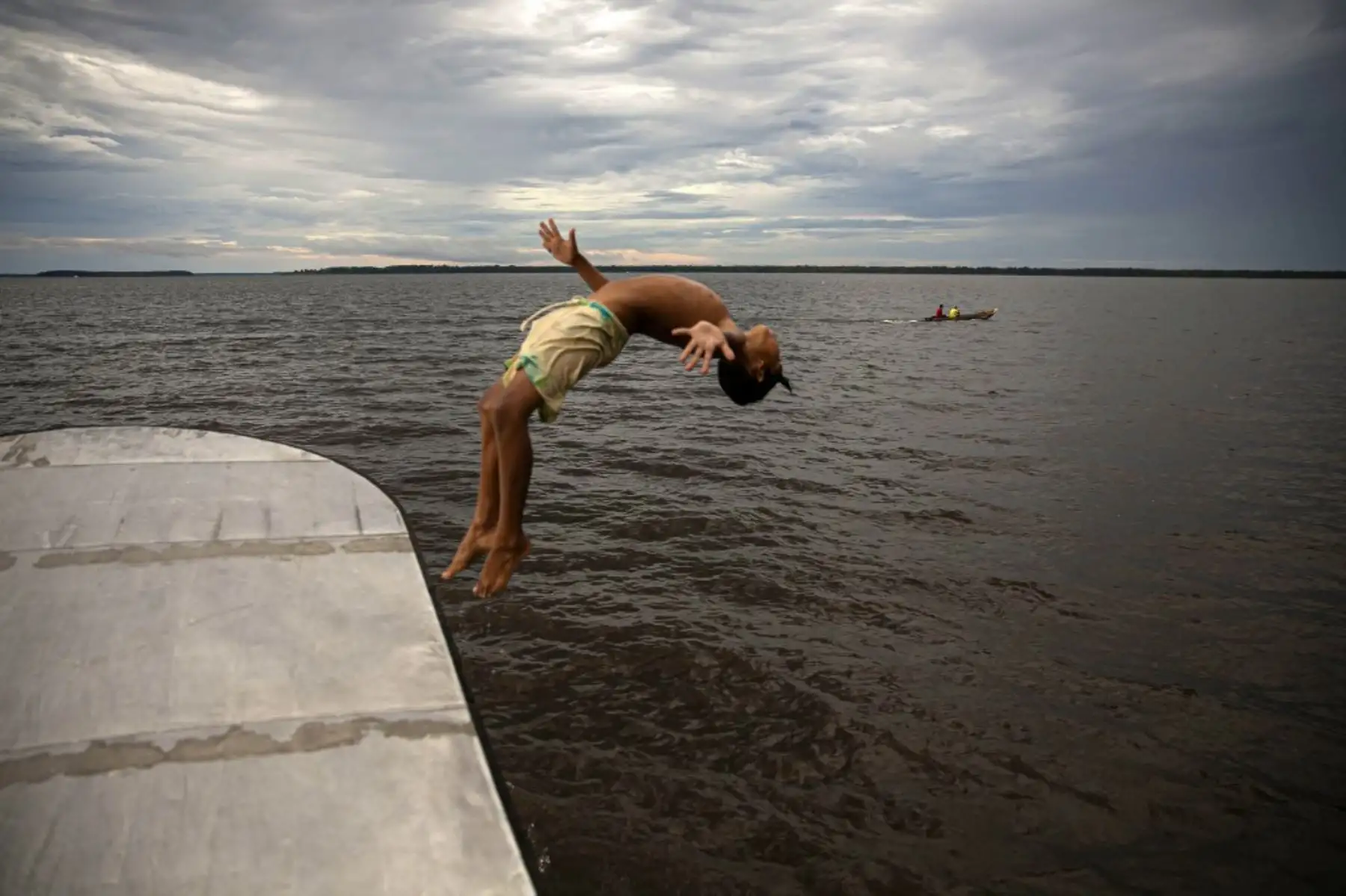 Un niño salta al agua en la bahía de Melgaco, al suroeste de la isla de Marajo, en el estado de Pará, Brasil, en medio de la pandemia de coronavirus. Foto: AFP