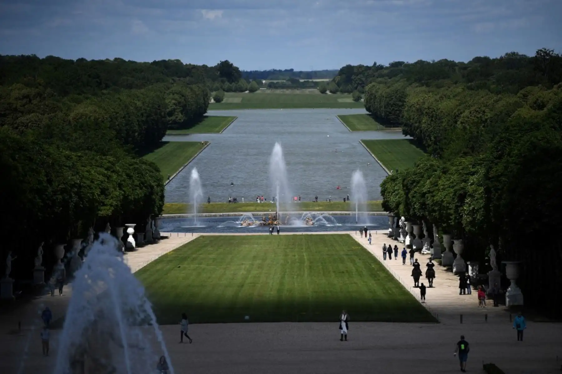 Un buen grupo de personas transita en el parque del histórico Palacio de Versalles, cerca de París, Francia. Foto: AFP
