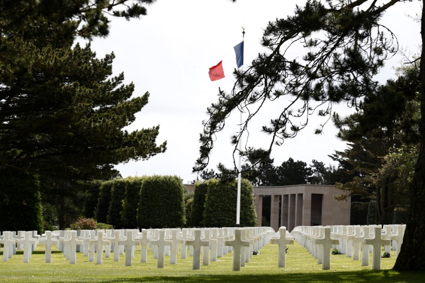 La bandera francesa ondea sobre las lápidas de los soldados asesinados en el Cementerio y Memorial de Normandía en el 76 aniversario del desembarco del día D. Foto: AFP