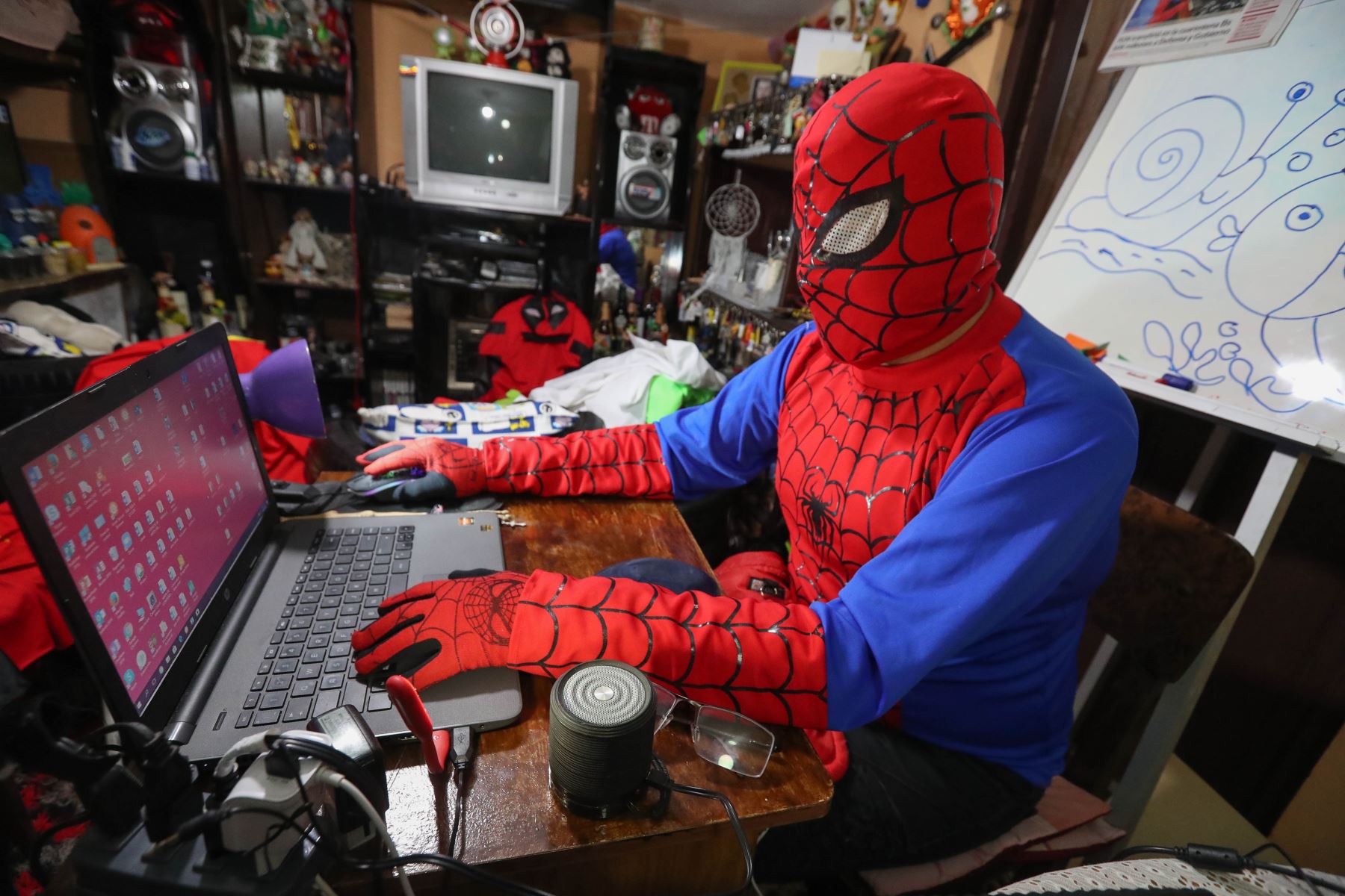 Imagen fechada el 10 de junio que muestra al boliviano Jorge Villarroel, alias "Doctor profe", quien con la máscara y el atuendo del superhéroe Spiderman, da su clase virtual de artes plásticas a través de internet, en La Paz (Bolivia). Foto: EFE