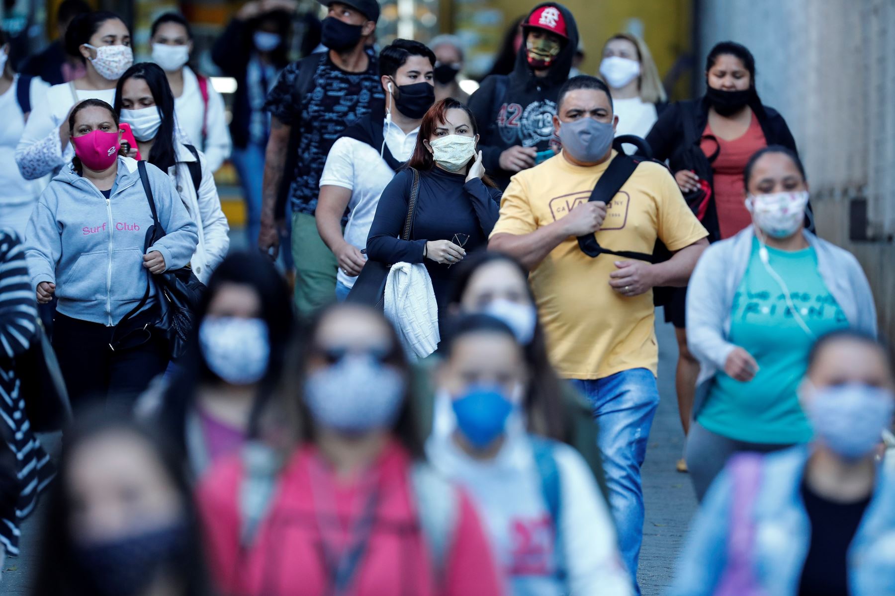 Personas con tapabocas caminan por una calle este viernes, en Sao Paulo (Brasil). Foto: EFE