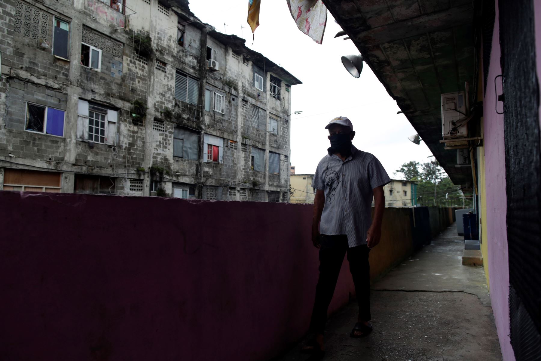 Un hombre camina por los pasillos de varias viviendas mientras personal médico realiza pruebas de coronavirus en Ciudad de Panamá (Panamá). Foto: EFE
