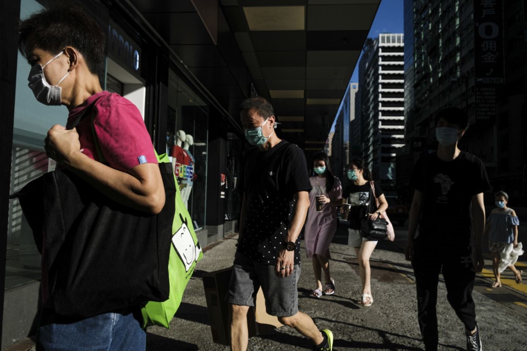 Los peatones caminan por una calle en Hong Kong. Foto: AFP