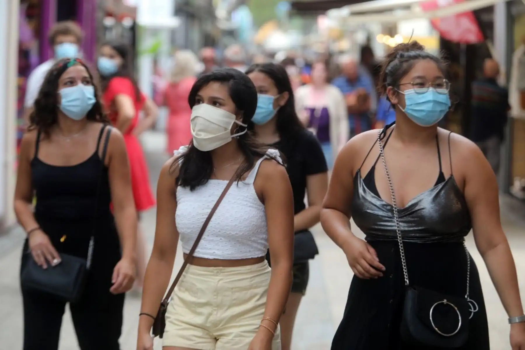 Los peatones que usan máscaras protectoras debido a la pandemia del coronavirus COVID-19 caminan por las tiendas en una calle de Argeles-sur-Mer, cerca de Perpiñán, sur de Francia. Foto: AFP