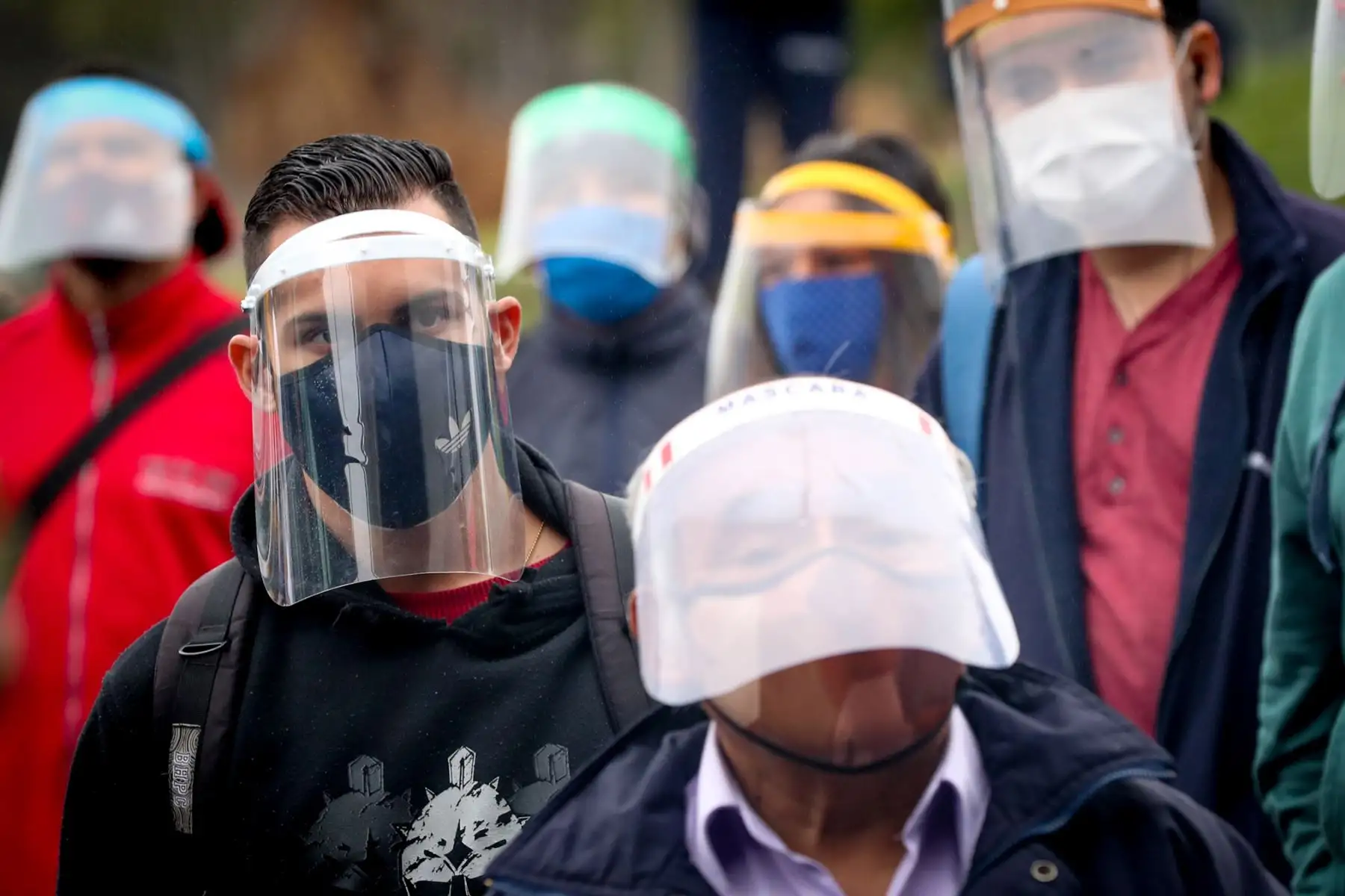 Muchas personas indican que no usan la mascarilla junto al escudo facial porque no se entiende lo que dicen o porque tienen mucho calor, reduciendo así los cuidados frente al coronavirus. Foto: Andina