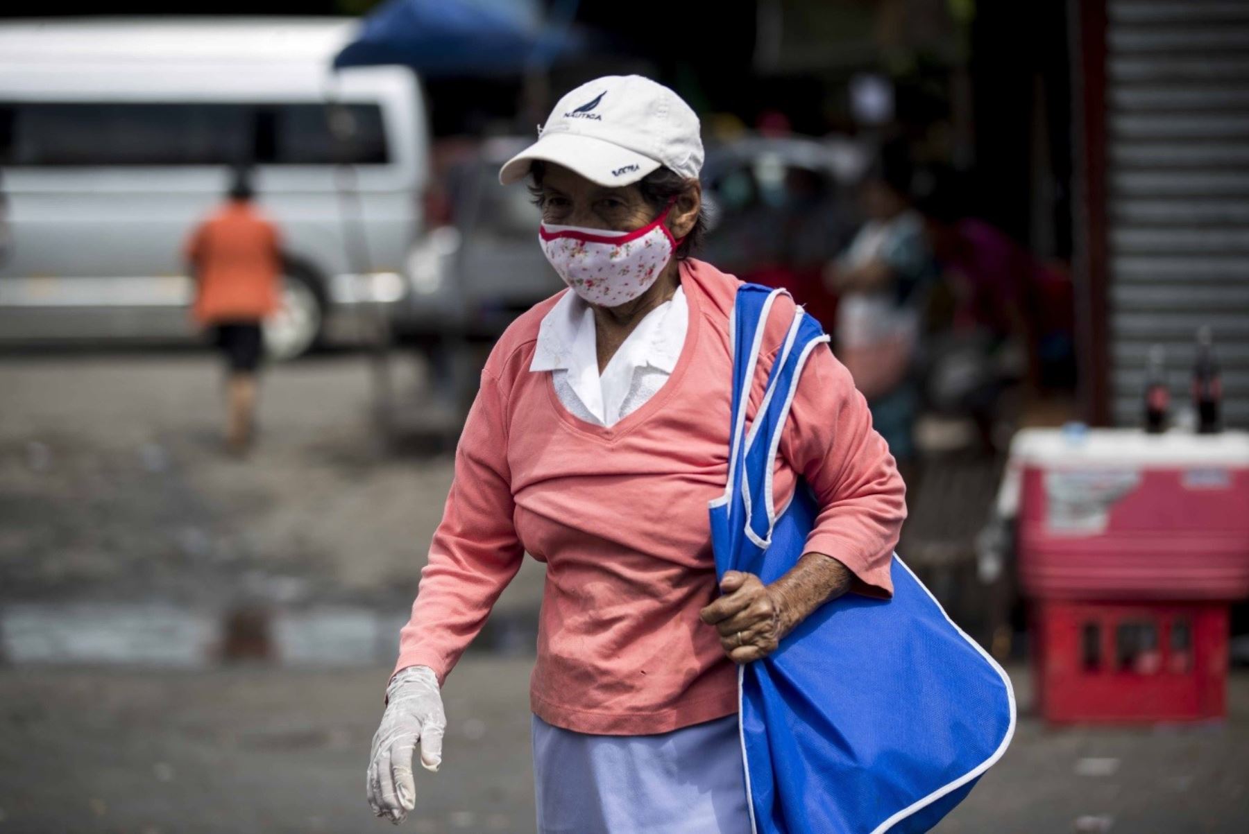 Una mujer usa tapabocas este martes mientras camina por un mercado callejero en Managua (Nicaragua). Foto: EFE