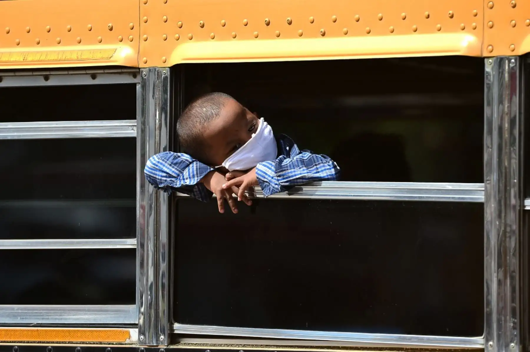 Un niño del grupo étnico miskito mira por la ventana de un autobús cuando su familia regresa a La Mosquitia debido a la pérdida de sus empleos debido a la pandemia COVID-19, en Tegucigalpa, Honduras. Foto: AFP