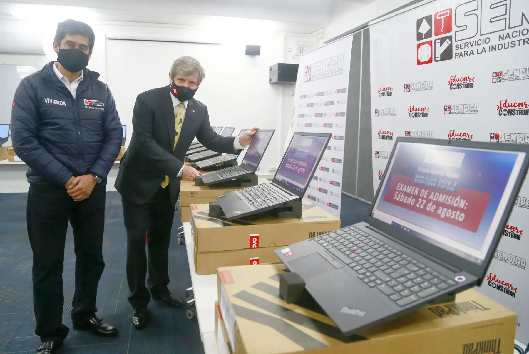 El ministro de Vivienda, Carlos Lozada y el Embajador de Suiza en el Perú, Markus-Alexander Antonietti muestran las laptops que fueron donadas por parte de la Cooperación Suiza Alemana para apoyar a Sencico en la implementación de talleres tecnológicos. Foto: Ministerio de Vivienda