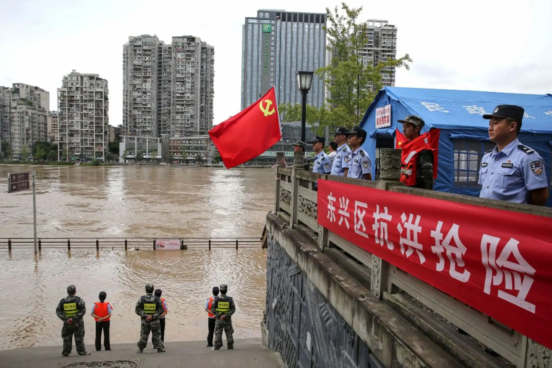 Agentes de policía montan guardia a lo largo del crecido río Tuojiang luego de las fuertes lluvias en Neijiang, en la provincia de Sichuan, suroeste de China. Sichuan declaró su alerta de inundación al segundo nivel más alto después de las fuertes lluvias continuas que dañaron tierras de cultivo y infraestructura de transporte, según la agencia oficial de noticias Xinhua.

Foto: AFP