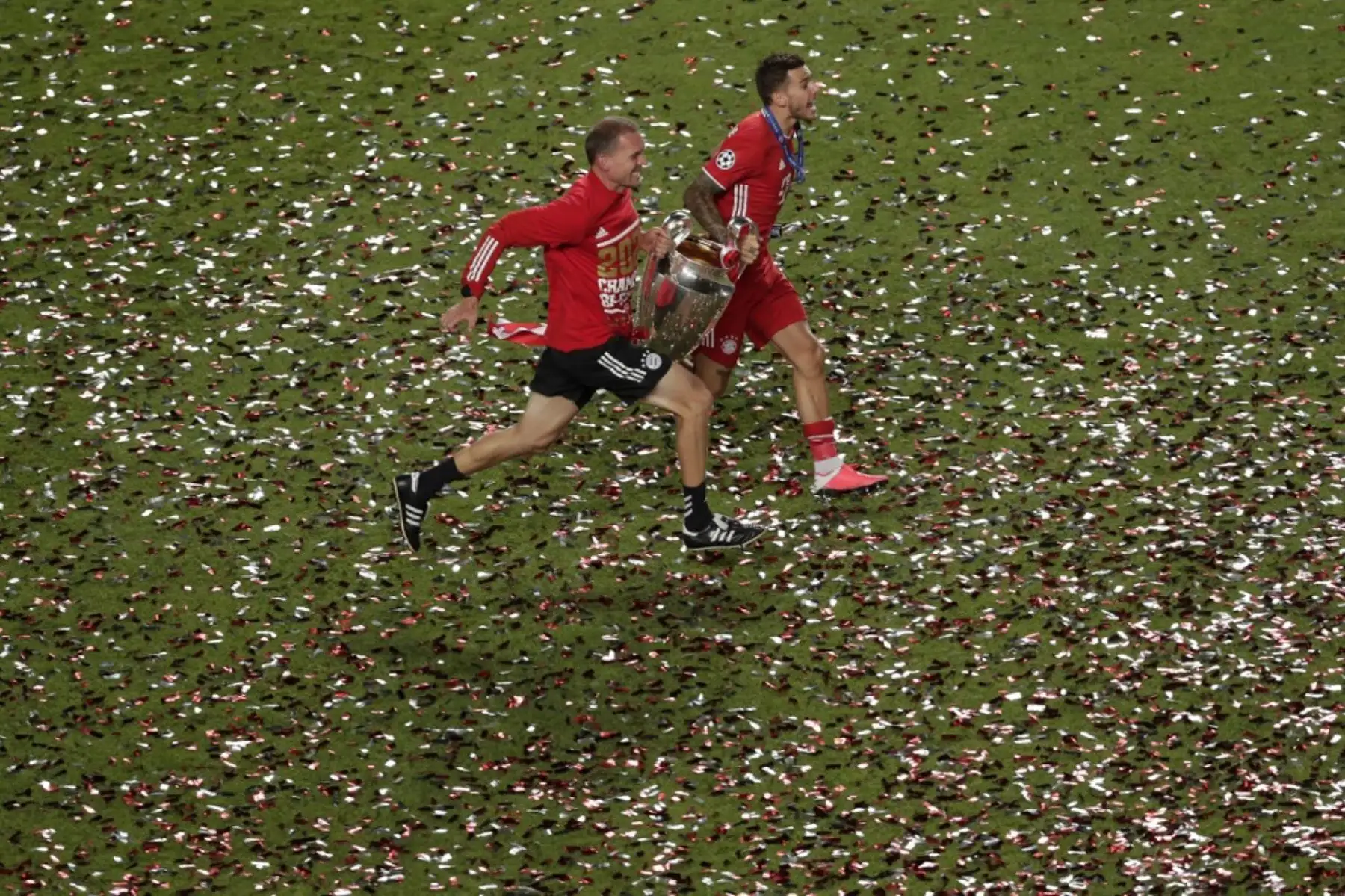 El defensor francés del Bayern Munich Lucas Hernandez corre por el campo con el trofeo después de que el Bayern ganó el partido de fútbol final de la UEFA Champions League entre Paris Saint-Germain y Bayern Munich en el estadio Luz de Lisboa. Foto: AFP