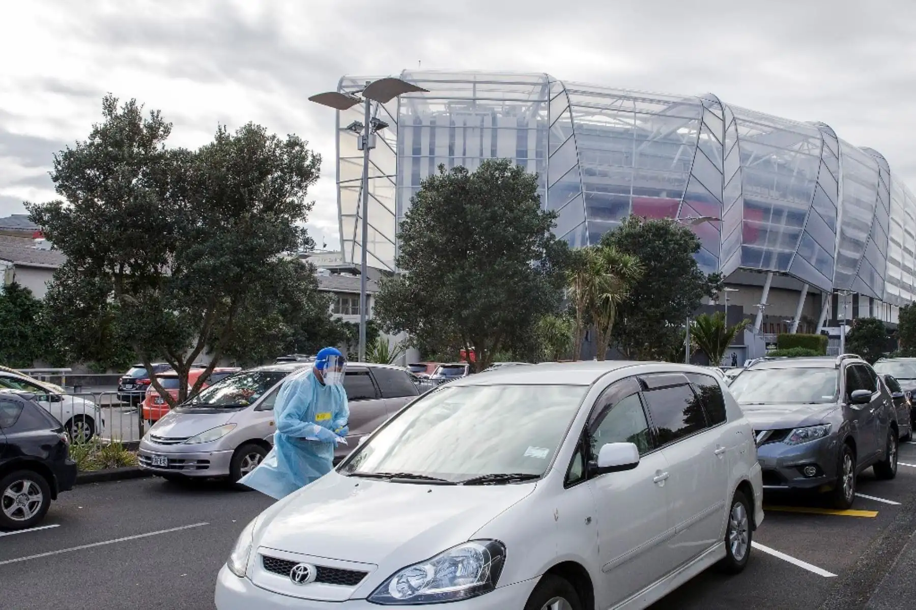 Un trabajador de la salud habla con un automovilista en la instalación de una estación de prueba covid-19 en Eden Park, National Sports Stadium, en Auckland. Foto: AFP