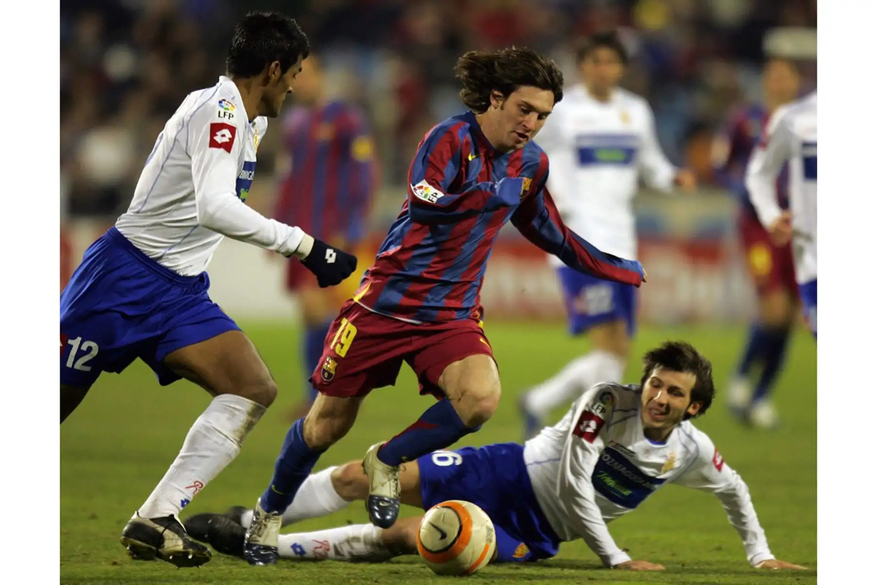 El argentino de Barcelona Lionel Messi compite con los zaragozanos Delio Toledo y Albert Celades durante su partido de fútbol de la Copa del Rey en el estadio Romareda de Zaragoza, el 26 de enero de 2006. Foto: AFP
