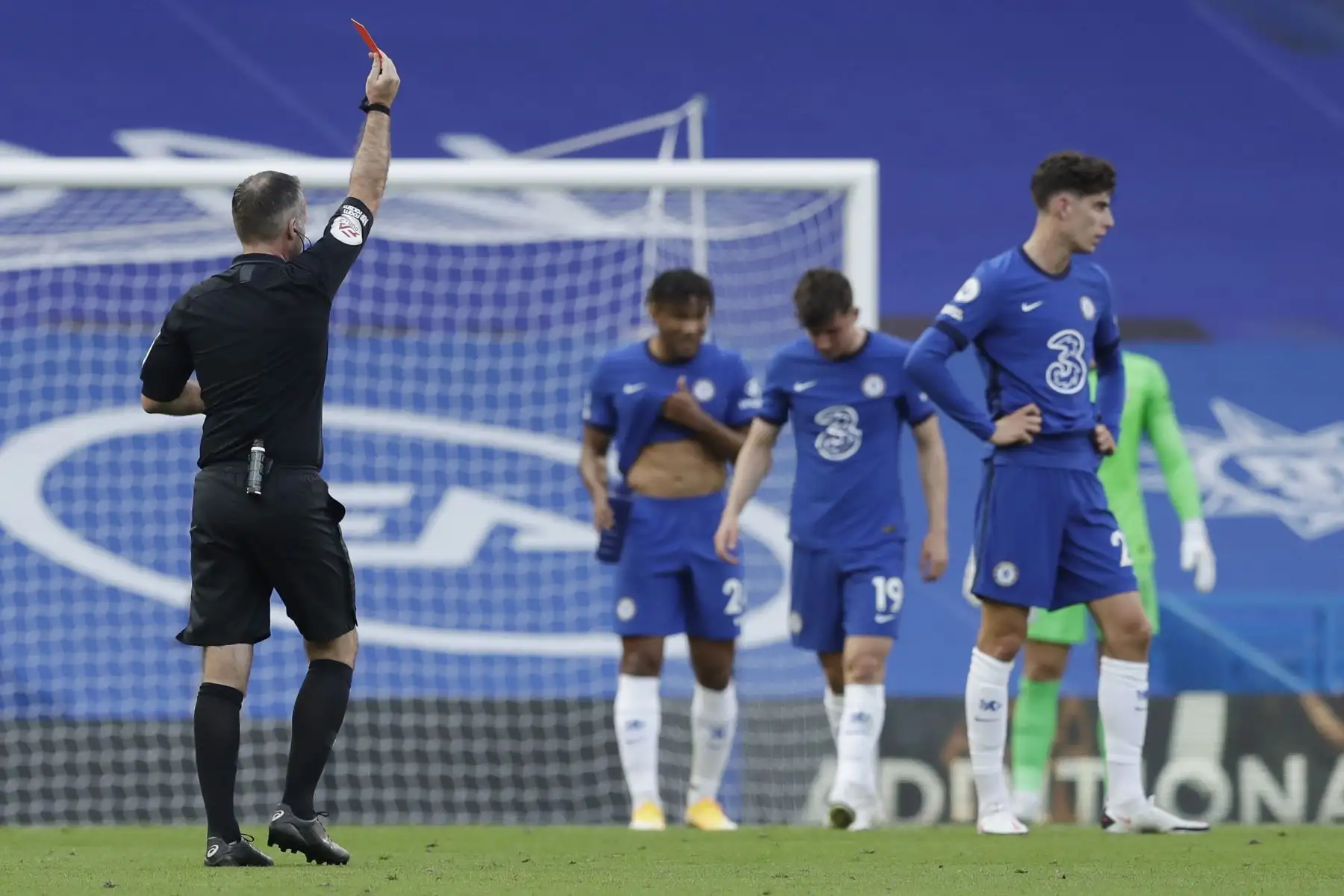 El árbitro Paul Tierney le da una tarjeta roja al defensor danés de Chelsea Andreas Christensen durante el partido de fútbol de la Premier League inglesa entre Chelsea y Liverpool. Foto: AFP