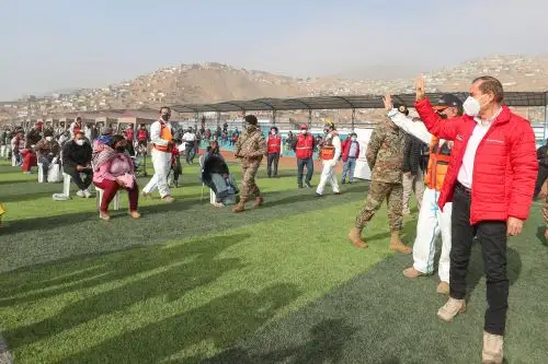 Peruvian Prime Minister Walter Martos supervises the delivery of food baskets to vulnerable families in Lima