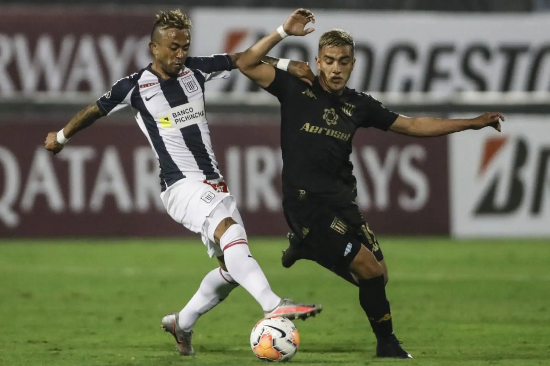 El mediocampista argentino del Racing Club Leonel Miranda compite por el balón con el mediocampista de Alianza Lima de Perú Joazhino Arroe durante su partido de fútbol a puerta cerrada de la fase de grupos de la Copa Libertadores en el Estadio Alejandro Villanueva en Lima. Foto: AFP