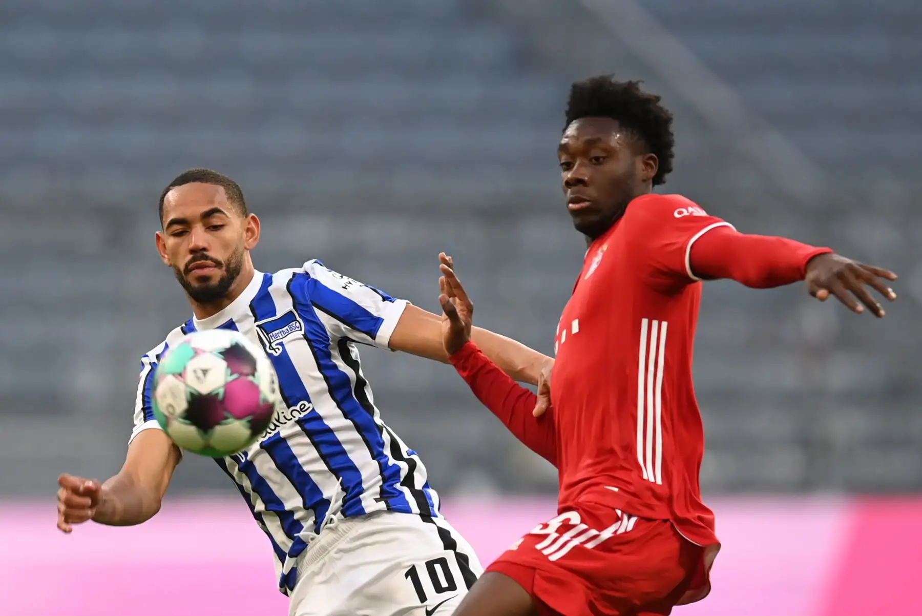 El mediocampista alemán de Wolfsburg, Yunus Malli, y el mediocampista canadiense del Bayern Munich, Alphonso Davies, compiten por el balón durante el partido de fútbol de la Bundesliga. Foto: AFP