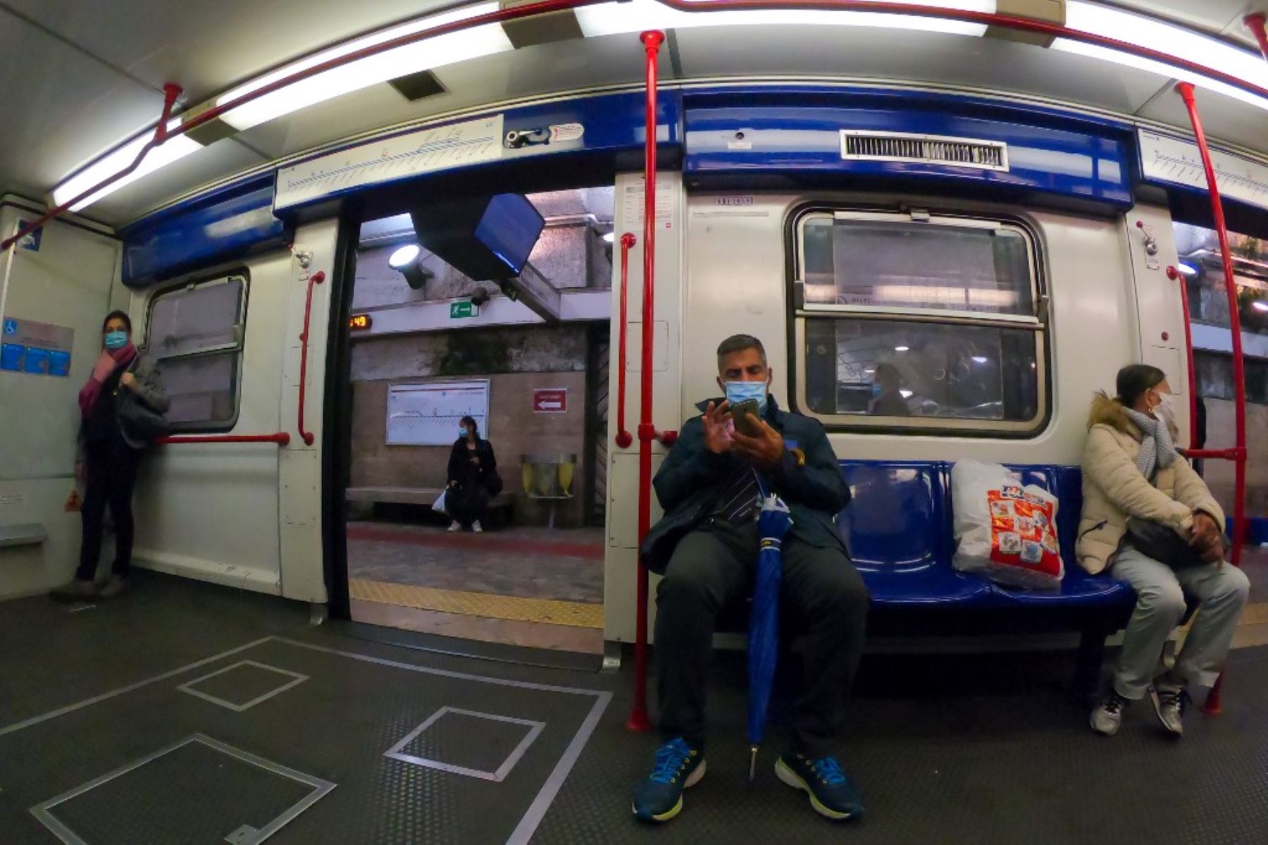Los viajeros con máscaras protectoras se paran en la Línea B del metro en medio de la pandemia de Covid-19, en Roma. Foto: AFP