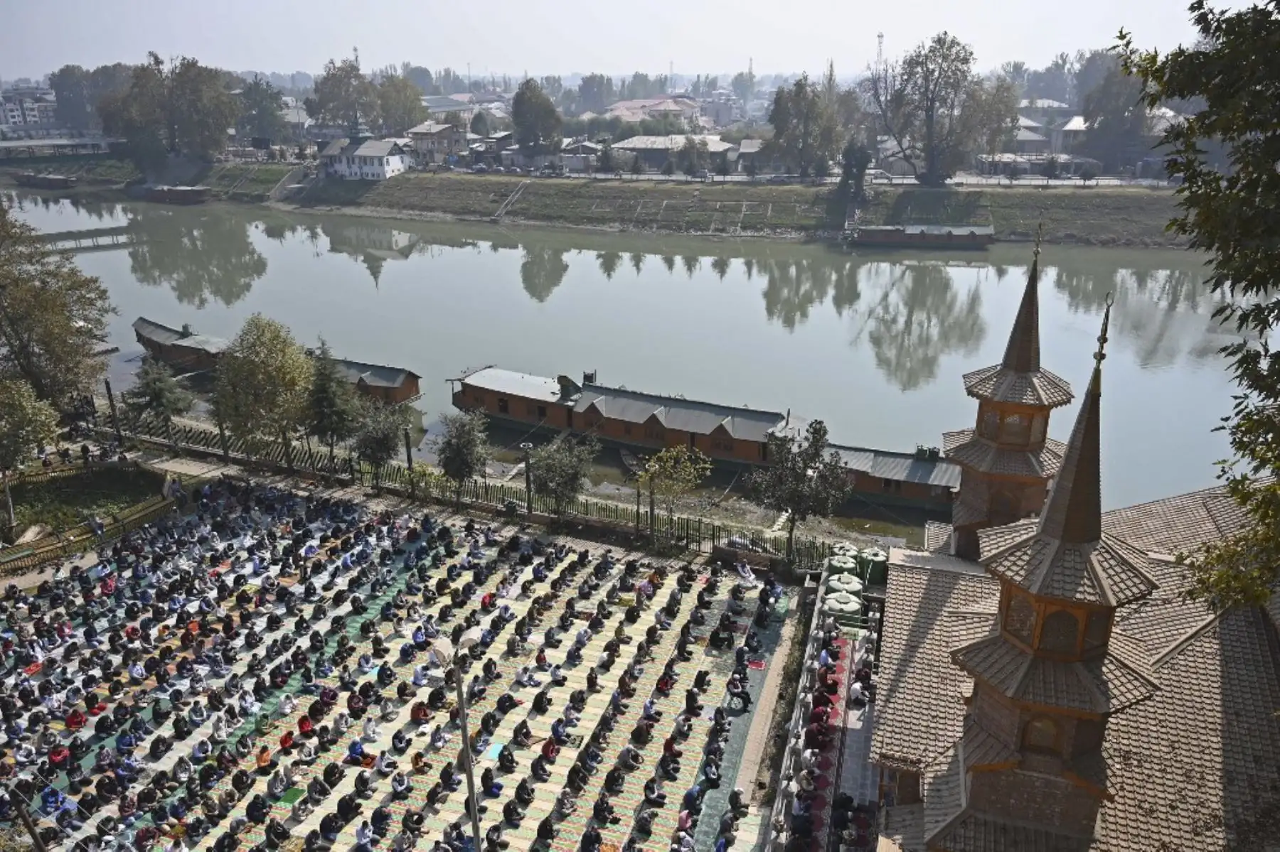 Musulmanes de Cachemira ofrecen oraciones de los viernes a orillas del río Jhelum mientras mantienen el distanciamiento social como medida preventiva contra el coronavirus, en Srinagar. Foto: AFP