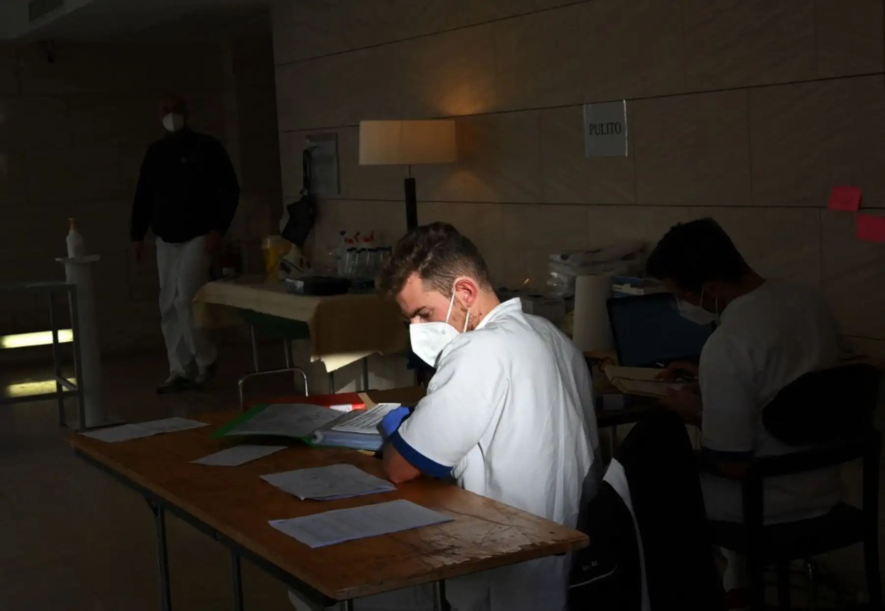 Personal médico se sienta en los escritorios del vestíbulo del hotel Sheraton Parco de Medici de Roma. Foto: AFP