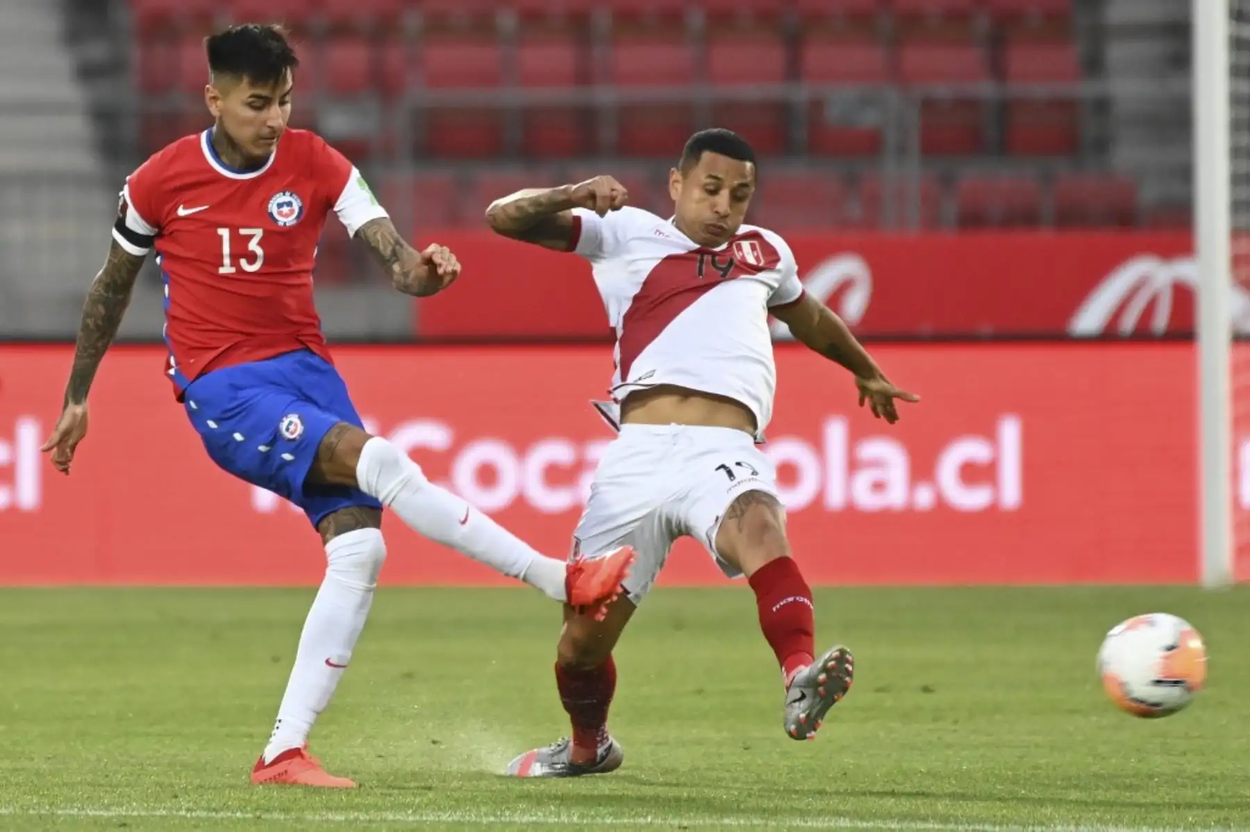 El chileno Erick Pulgar (izq.) Y el peruano Yoshimar Yotun compiten por el balón durante el partido de fútbol a puerta cerrada clasificatorio sudamericano para la Copa Mundial de la FIFA 2022 en el Estadio Nacional de Santiago. Foto: AFP