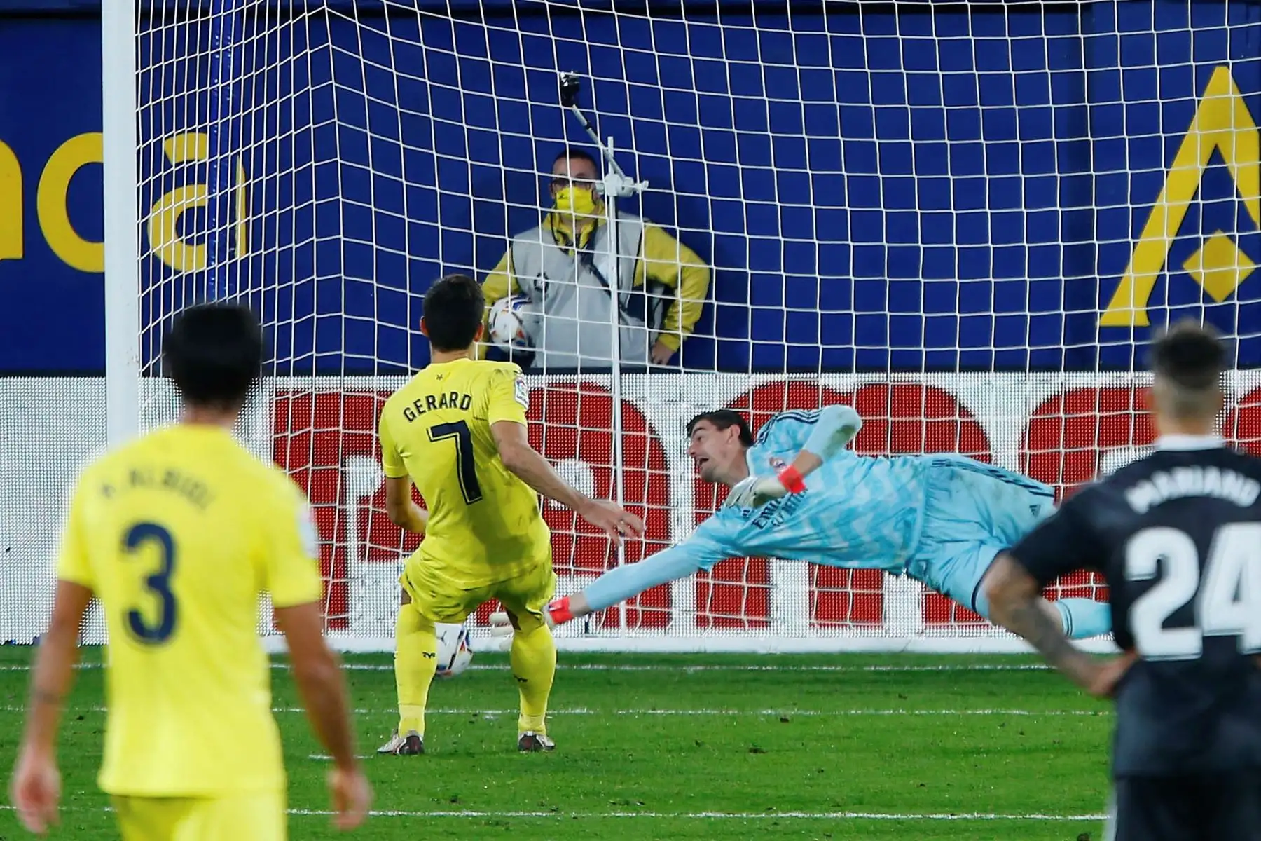El delantero del Villarreal Gerard Moreno marca gol ante el portero del Real Madrid, el belga Thibaut Courtois durante el partido de Liga que disputan en el estadio de la Cerámica. Foto: EFE