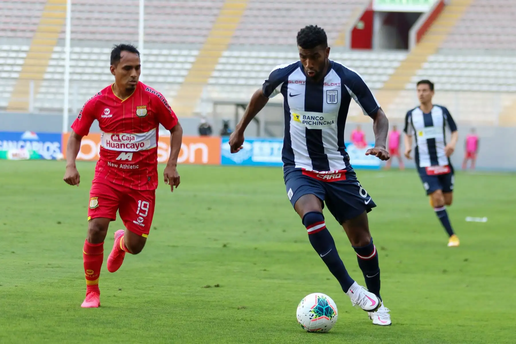 El futbolista  C. Ascues  de  Alianza Lima, disputa la pelota con el jugador de   Sport Huancayo  durante el partido de la fase 2 por la fecha 9 de la Liga 1 , en el Estadio Nacional.  
Foto: @LigaFutProfdel