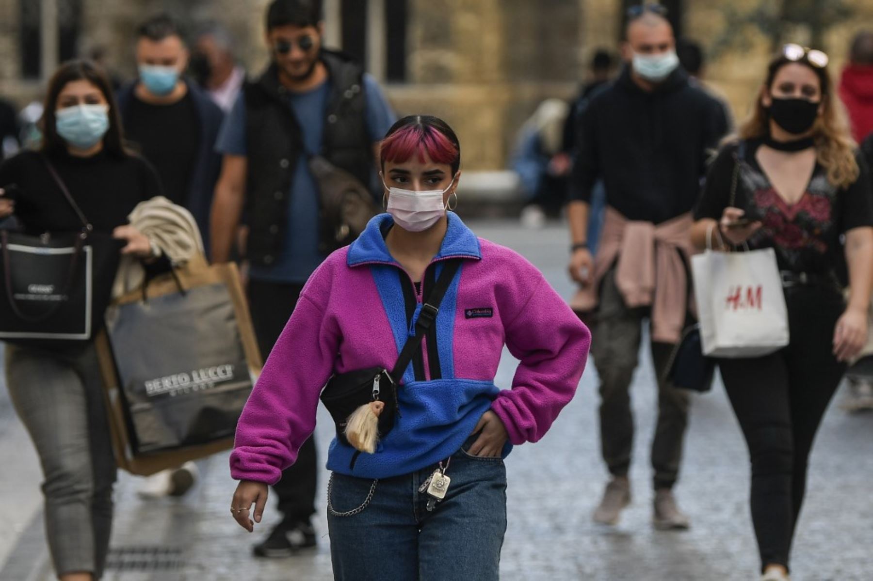 Los peatones, con máscaras faciales, caminan en la principal calle comercial de Atenas. Foto: AFP