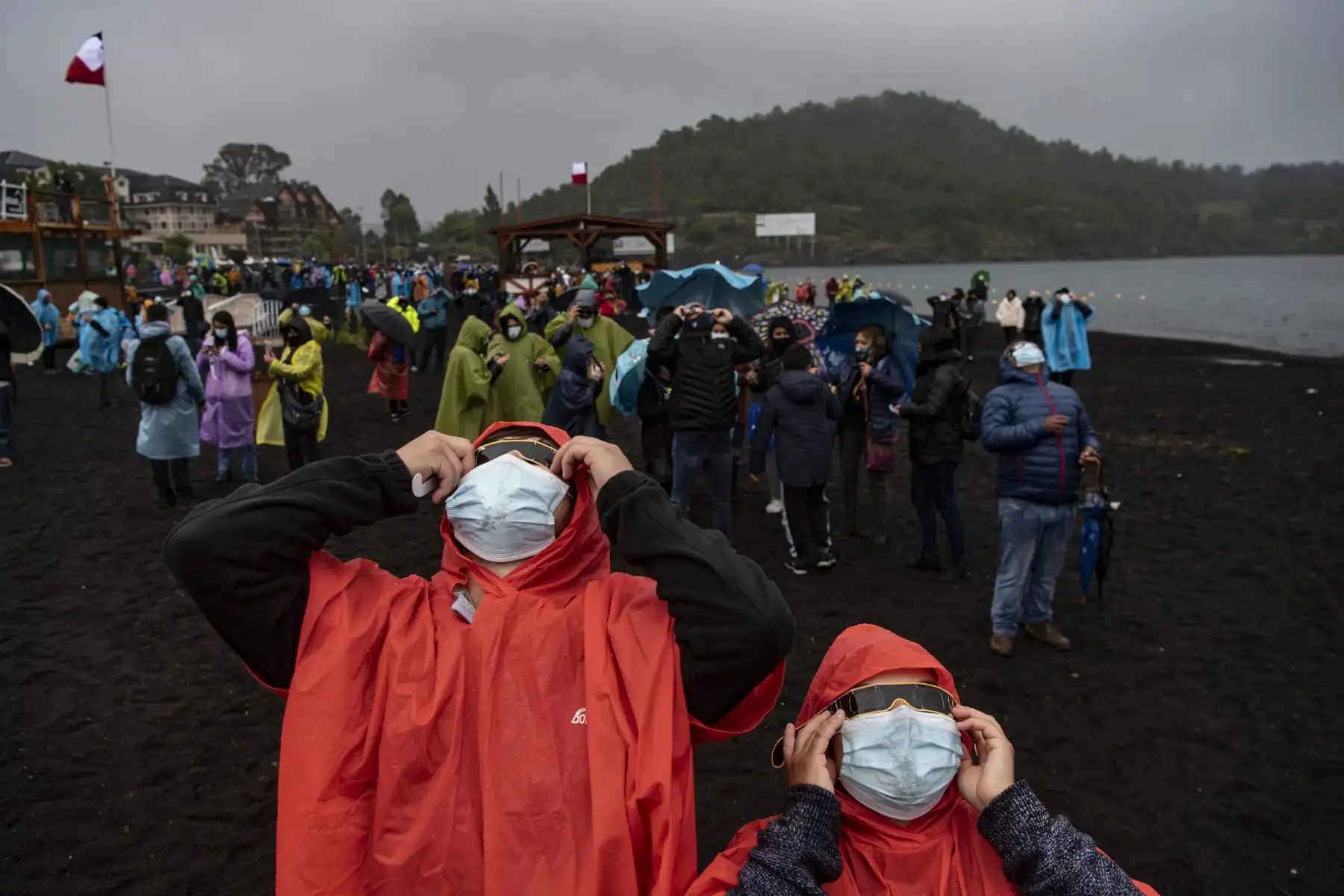 La gente observa el eclipse total de sol en las orillas del lago Villarrica en Pucón, sur de Chile. Foto: AFP