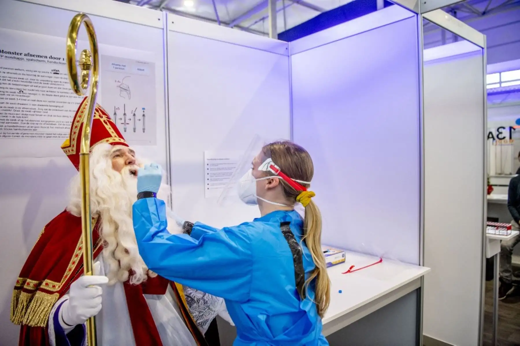 Un hombre se viste mientras Saint-Nicolas se somete a una prueba de detección de Covid-19 en un centro de detección de calles en Schiphol. Foto: AFP